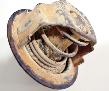 the corrosion formed on removable cooling system components like this old thermostat often indicate how badly the radiator is corroded.