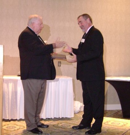 Marc Reynolds, MAHLE Clevite Canada, ULC accepts ERI Supplier of the Year award from ERI President, Rick Miller