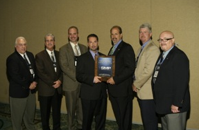 Bo Fisher, chairman of Federated Auto Parts (fourth from left) presents the Federated Outstanding Vendor of the Year Award to Standard Motor Products (L to R): Ken Wendling, Bob Kimbro, Matt Guden, Fisher, Bill Collins, Robert Frick and Alex Simmons. 