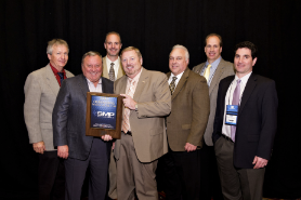 Rusty Bishop, CEO of Federated Auto Parts (fourth from left) presents the Federated 2011 Outstanding Vendor of the Year award to the team from Standard Motor Products (SMP). From left, Leon De Long, John Gethin, Matt Guden, Bishop, Ken Wendling, Bill Collins and Eric Sills.